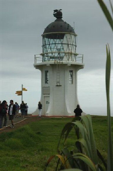 The sign post points to distant cities in other parts of the world